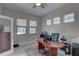 Bright office features tile flooring, three windows, and a ceiling fan for a comfortable workspace at 11222 Hawks Fern Dr, Riverview, FL 33569