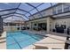 Inviting screened-in pool and patio with outdoor dining at 11222 Hawks Fern Dr, Riverview, FL 33569