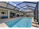 Backyard pool with screened enclosure and covered patio, perfect for outdoor entertaining at 11222 Hawks Fern Dr, Riverview, FL 33569