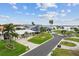 Beautiful street view with lush landscaping, palm trees, and a glimpse of the water nearby at 113 16Th St, Belleair Beach, FL 33786
