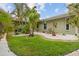 Serene backyard featuring lush greenery, a rock garden, and manicured landscaping at 113 16Th St, Belleair Beach, FL 33786