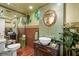 Unique bathroom with vintage vanity, green tiled walls, and artistic decor at 113 16Th St, Belleair Beach, FL 33786