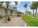Inviting walkway leading to a charming home with mature landscaping and serene waterfront views at 113 16Th St, Belleair Beach, FL 33786