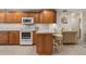 Well-equipped kitchen with stainless steel appliances, breakfast bar, and plenty of storage with tile backsplash at 113 16Th St, Belleair Beach, FL 33786