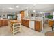 Open-concept kitchen featuring a center island, modern appliances, and seamless flow to living areas at 113 16Th St, Belleair Beach, FL 33786