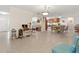 Spacious living area with tile floors, neutral tones, and open layout connecting to dining and kitchen at 113 16Th St, Belleair Beach, FL 33786