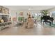 Bright living room with stone fireplace, large windows, and a grand piano offers a comfortable and elegant space at 113 16Th St, Belleair Beach, FL 33786