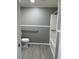 Bathroom with new toilet, shower, and safety bars at 11351 Edison Ave, New Port Richey, FL 34654