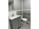 Bathroom features a gray vanity with modern fixtures and tiled backsplash at 11351 Edison Ave, New Port Richey, FL 34654