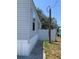 Side view of the home showing the vinyl siding, windows, and landscaped perimeter at 11351 Edison Ave, New Port Richey, FL 34654