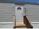 Close up of the new front door with decorative window and new wood stairs at 11351 Edison Ave, New Port Richey, FL 34654
