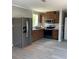 Open kitchen featuring stainless steel appliances, wood cabinets, and a large stainless refrigerator at 11351 Edison Ave, New Port Richey, FL 34654
