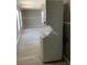 View of stackable washer and dryer, windows, wood-look flooring at 11351 Edison Ave, New Port Richey, FL 34654