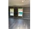 Bright living room featuring modern gray flooring, freshly painted gray walls, and new trim at 11351 Edison Ave, New Port Richey, FL 34654