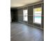 Spacious living room features wood-look flooring and plenty of natural light at 11351 Edison Ave, New Port Richey, FL 34654