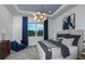 Serene main bedroom featuring a comfortable bed, stylish lighting, and a large window with scenic views at 11443 Shoreline Trl, Parrish, FL 34219