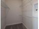 An empty walk-in closet features ample storage space, with metal shelving and carpeted floors at 11443 Shoreline Trl, Parrish, FL 34219
