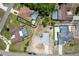 Aerial view of a beautiful home surrounded by neighborhood homes and lush trees at 12456 Spreading Oak Dr, Spring Hill, FL 34609