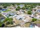Aerial view of a beautiful home surrounded by mature landscaping and lush trees at 12456 Spreading Oak Dr, Spring Hill, FL 34609
