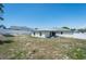 Wide backyard showcasing the exterior of a home, privacy fence and providing a view of the property's outdoor space at 12456 Spreading Oak Dr, Spring Hill, FL 34609