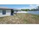 View of a large backyard with white fence and patio area at 12456 Spreading Oak Dr, Spring Hill, FL 34609