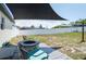 Spacious backyard featuring a shade, outdoor furniture, and a stone fire pit for gatherings at 12456 Spreading Oak Dr, Spring Hill, FL 34609