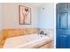Bright bathroom featuring a tub with marble tile, complementing the room's relaxing ambiance at 12456 Spreading Oak Dr, Spring Hill, FL 34609