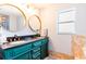 Elegant primary bathroom features double sinks, quartz countertops, and a walk-in shower at 12456 Spreading Oak Dr, Spring Hill, FL 34609
