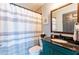 Cozy bathroom with shower featuring modern vanity with dark countertops and matching mirror at 12456 Spreading Oak Dr, Spring Hill, FL 34609