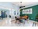 Contemporary dining room features stylish decor, modern light fixture and art at 12456 Spreading Oak Dr, Spring Hill, FL 34609