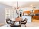 Open dining and kitchen area with wooden cabinets, modern appliances, and natural light at 12456 Spreading Oak Dr, Spring Hill, FL 34609