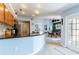 Bright kitchen with granite countertops, tile floors, and a view of the dining area through an arched entryway at 12456 Spreading Oak Dr, Spring Hill, FL 34609