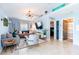 Inviting living room boasts vaulted ceilings, tile flooring, and an open doorway to the rest of the home at 12456 Spreading Oak Dr, Spring Hill, FL 34609