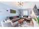 Cozy living room featuring stylish furniture, vaulted ceilings, and an abundance of natural light at 12456 Spreading Oak Dr, Spring Hill, FL 34609