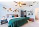 Spacious main bedroom with ceiling fan, carpeted floors, an ensuite bath, and walk-in closet at 12456 Spreading Oak Dr, Spring Hill, FL 34609