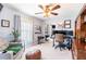 Well-lit office space with a ceiling fan, complete with a desk, dual monitors, and shelving at 12456 Spreading Oak Dr, Spring Hill, FL 34609