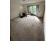 Bedroom with large carpet, sliding glass door and a closet at 135 Pinewinds Blvd, Oldsmar, FL 34677