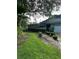 Shows the blue house and front yard, including a lawn and driveway at 135 Pinewinds Blvd, Oldsmar, FL 34677