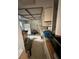 A view of a kitchen shows appliances and cabinets with scattered household items at 135 Pinewinds Blvd, Oldsmar, FL 34677