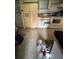 Shows a vintage kitchen with dated appliances and fixtures, and a disorganized floor at 135 Pinewinds Blvd, Oldsmar, FL 34677