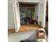 Shows the kitchen through shutters and an open pass-through, revealing a cluttered interior at 135 Pinewinds Blvd, Oldsmar, FL 34677