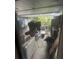 Enclosed lanai filled with various household items, plants, and storage solutions at 135 Pinewinds Blvd, Oldsmar, FL 34677