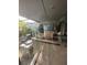 Lanai area is cluttered with plants, boxes, and storage containers at 135 Pinewinds Blvd, Oldsmar, FL 34677