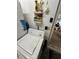 Laundry area with a washing machine and shelving at 135 Pinewinds Blvd, Oldsmar, FL 34677