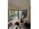 Untidy living room with sliding glass doors leading to a patio at 135 Pinewinds Blvd, Oldsmar, FL 34677