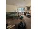 Image shows a cluttered living room with boxes and an open view of the kitchen at 135 Pinewinds Blvd, Oldsmar, FL 34677