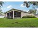 Spacious backyard featuring a screened lanai, perfect for enjoying outdoor living and entertainment at 13813 Sigler St, Riverview, FL 33579