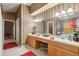 Spacious bathroom boasts a double vanity with stylish wallpaper, a mirror, and tile floors at 13813 Sigler St, Riverview, FL 33579