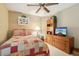 Bedroom with ceiling fan, warm tones, and wooden furniture at 13813 Sigler St, Riverview, FL 33579