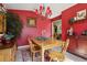Dining room with red walls, wooden furniture, bright windows, and a vintage feel at 13813 Sigler St, Riverview, FL 33579